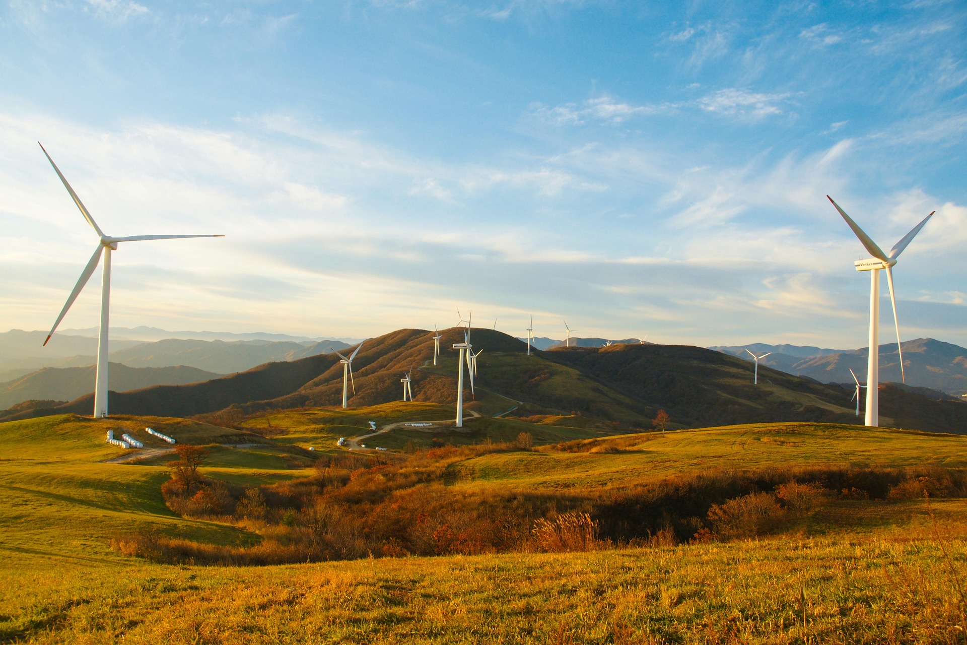 Wind turbines on rolling hills with autumn landscape
